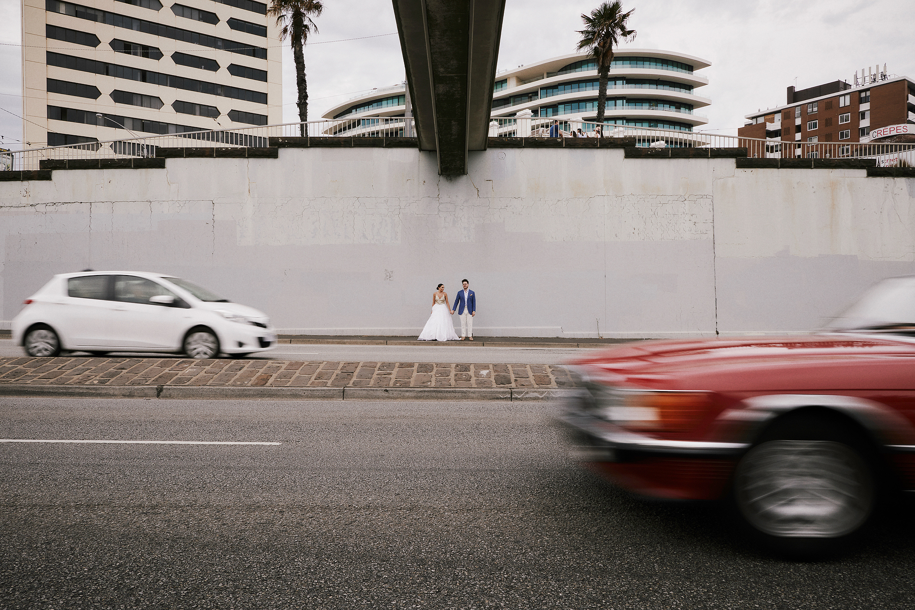Matisse and Goldy crossing a St Kilda street on their wedding day